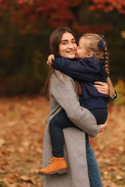 Two sisters walk in the park in autumn time. Childhood. season and people consept-happy family. Portrait of happy sisters in forest