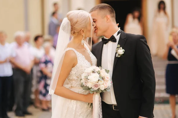 Belo casal desce as escadas da igreja após a cerimônia de casamento — Fotografia de Stock