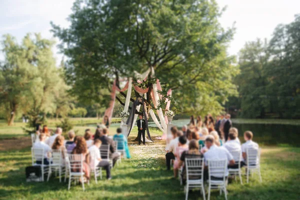 Groom stand by big tree and waiting for bride. Wedding ceremony