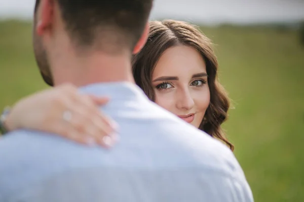 Beautiful woman hug her belowed man. Hand with engagement ring — Stock Photo, Image