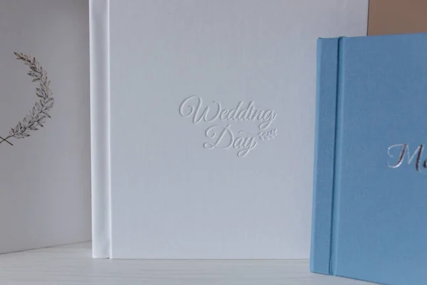 Photobook with different lettering on white wooden table — Stock Photo, Image