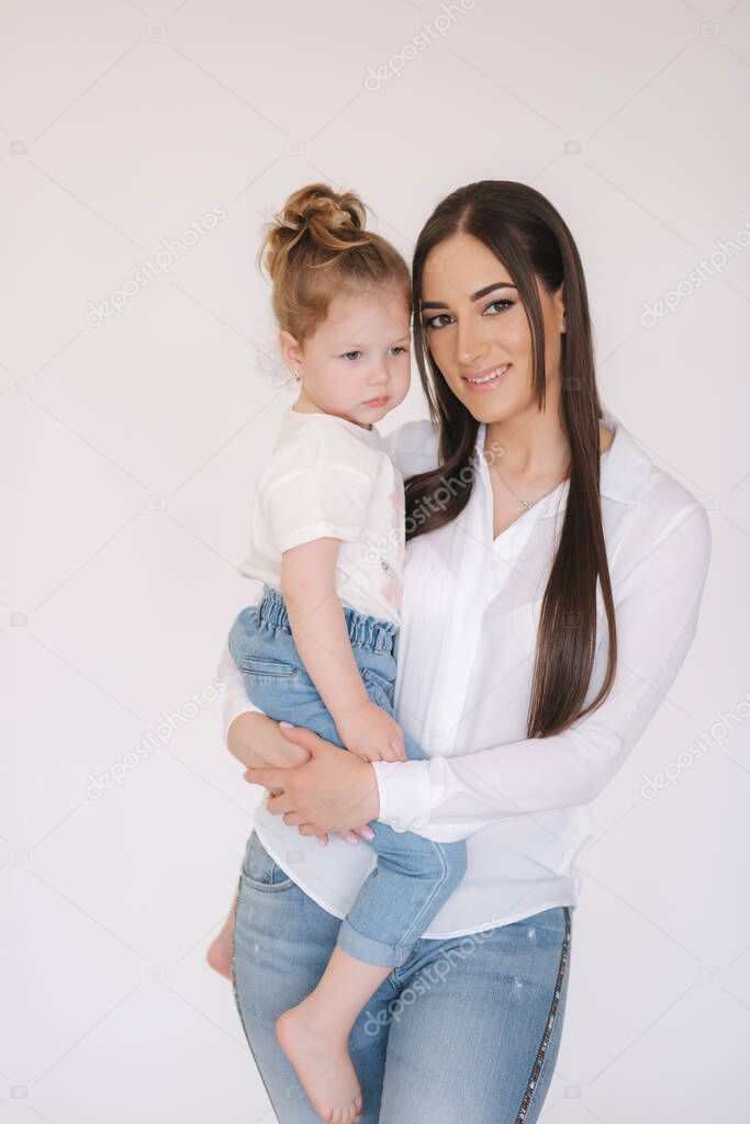 Portrait of Little girl with mom in studio. White background