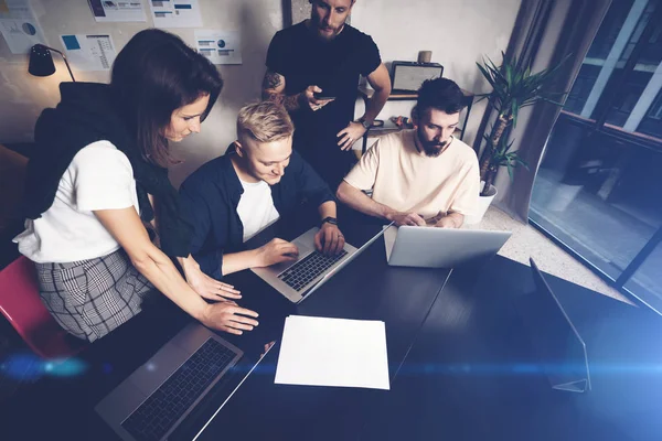 Medewerkers aan het werk. Groep jonge zakenmensen in trendy casual kleding die samenwerken in creatief kantoor — Stockfoto