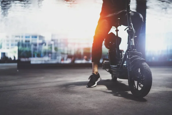 Electric urban transportation.Young man ready to ride his electric scooter bike in the center of a city. — Stock Photo, Image