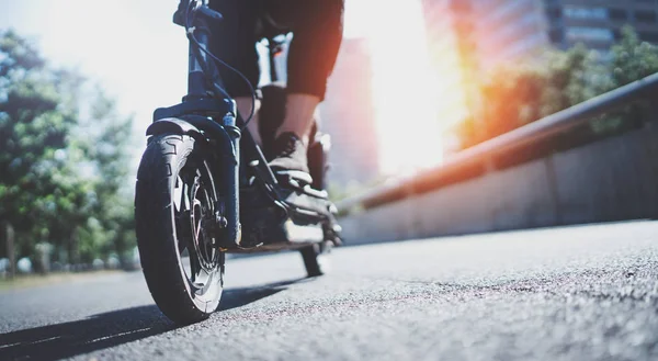 Electric urban transportation.Young man ready to discover ride urban city by electric scooter. Wide. Flare — Stock Photo, Image