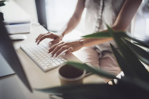 Självsäker ung affärskvinna med stationär dator i moderna arbetsplats på coworking office. Suddig bakgrund. — Stockfoto