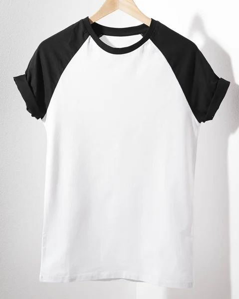 Front view of American Hipsters retro classic tshirt clothes. Blank template of vintage t-shirt hanging on a hanger on white background. Closeup. — Stock Photo, Image