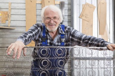 Kullanarak çalışan makine mobilya marangoz Atölyesi'nde yapmak gördüm. Tel çekirdeği üzerinde uyumak yatak. Küçük mobilya Fabrikası'nda el yapımı iş