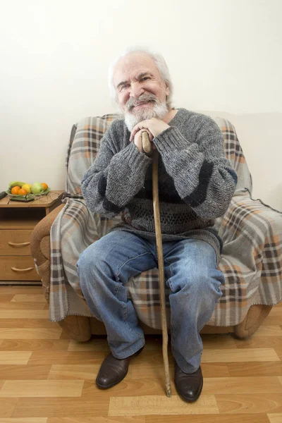 一个孤独 有魅力 不气馁的祖父坐在家里的扶手椅上 回想过去的岁月 回忆着生活中的事件 — 图库照片