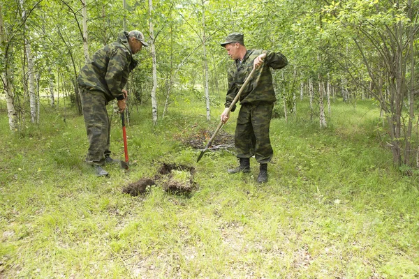 Forest firefighters conduct exercises to prevent a fire in the forest. Firemen put out fire in the forest. Firefighters close the ground where the fire in the forest was burning.