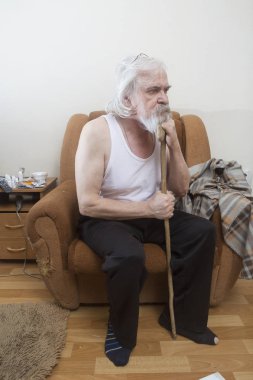 Katarakt ve Glokom, göz hastalığı muzdarip bir eski yalnız hasta zavallı adam, tek başına bir sandalyede oturur.
