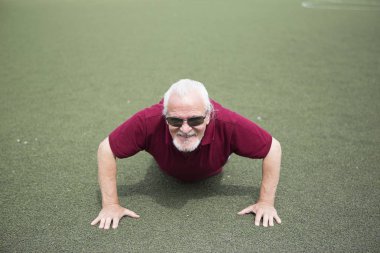 Komuta sizde açık havada spor stadyumunda pratiği yapıyor. Sağlıklı yaşam ve spor için her kişi eğitim durumu kavramı. Kamuya açık bir yerde mevcut spor malzemeleri.