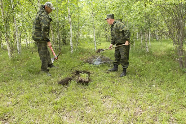 Forest firefighters conduct exercises to prevent a fire in the forest. Firemen put out fire in the forest. Firefighters close the ground where the fire in the forest was burning.