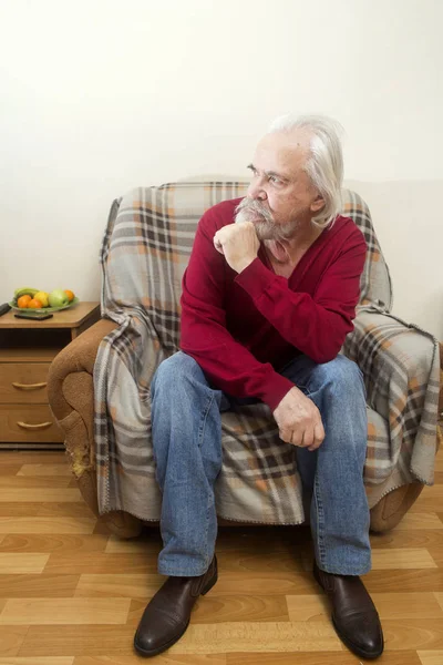 El anciano en el sillón en casa — Foto de Stock