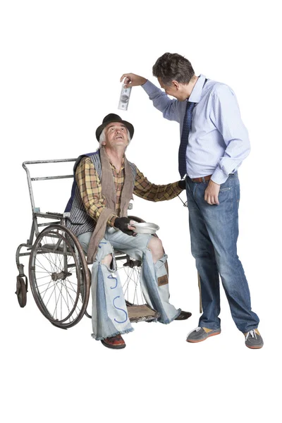 Beggar asking for alms while sitting in a wheelchair — Stock Photo, Image