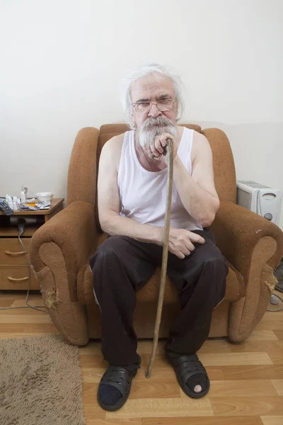 Old sick lonely man in the armchair at home — Stock Photo, Image