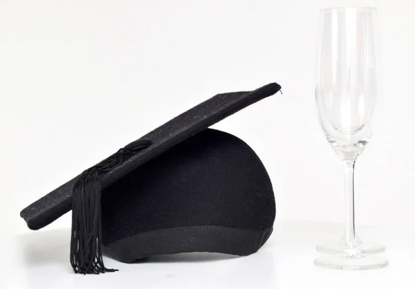 Graduation celebration with graduation cap and champagne glasses