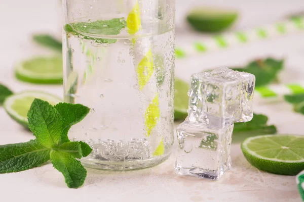 Detox water with lime and mint in glass. Mojito cocktail. on a white background