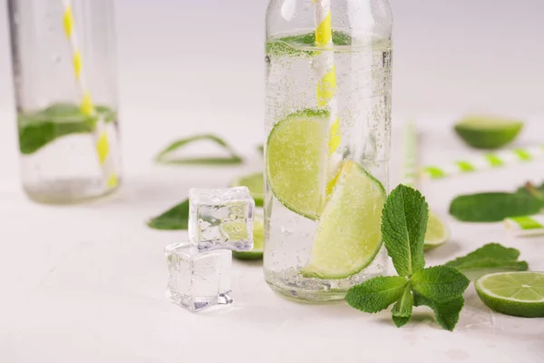 Detox water with lime and mint in glass. Mojito cocktail. on a white background