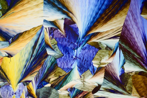 Colorful micro crystals in polarized light. Photo through a micr — Stock Photo, Image