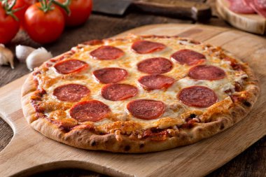 Lezzetli taze ev yapımı biberli pizza üzerinde ahşap pizza çekme.