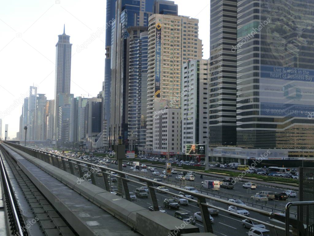 DUBAI, UAE. Dubai's downtown architecture with metro monorail train arriving at the station.