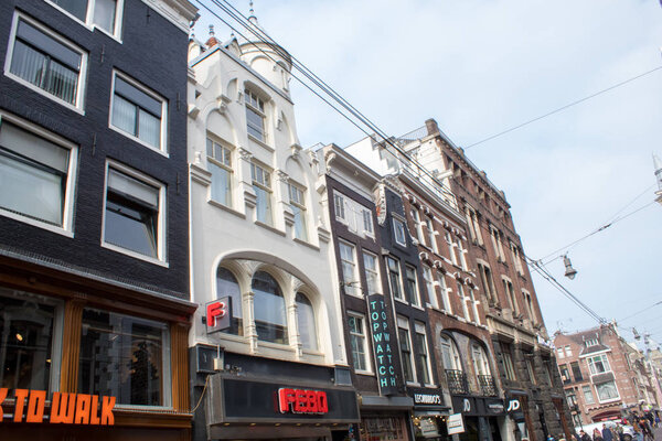 Amsterdam/Netherlands, April 06, 2019: Authentic Amsterdam streets. Architecture, transport and bustle of the townspeople and tourists on the streets.