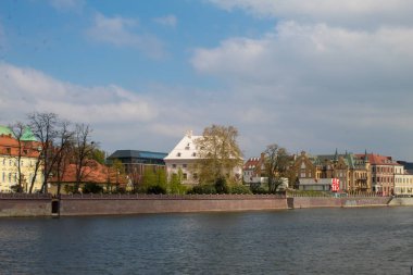 Wroclaw / Poland - April 22 2019: Panorama of the historical Polish city and reflection in the Odra River, Wroclaw Embankment.
