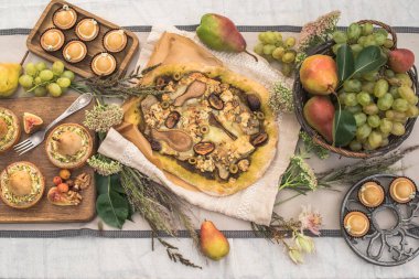 bahçede şenlikli masaya lezzetli kekler, pizza, armut ve meyve ile tartlets Üstten Görünüm