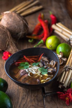 Ahşap masa üzerinde siyah kase Vietnamca Pho çorbası