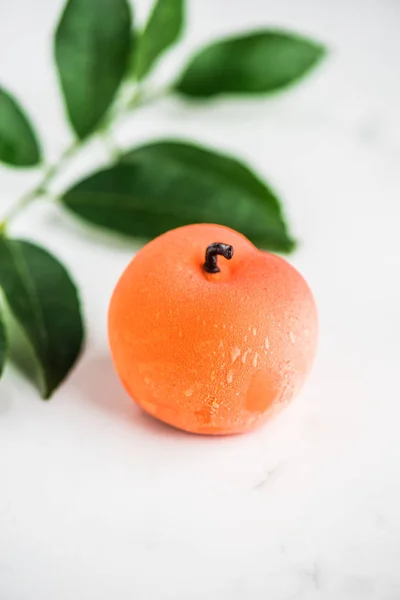 sweet candy in exotic fruit shape on white background with leaves