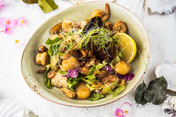 Oriental seafood snack with vegetables served in bowl