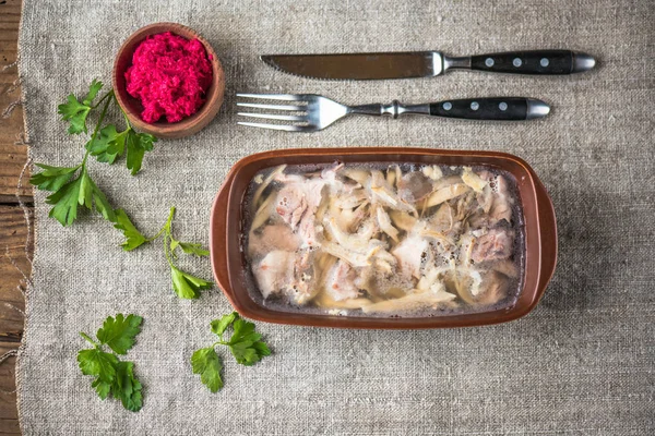 Homemade meat aspic in dish on tablecloth