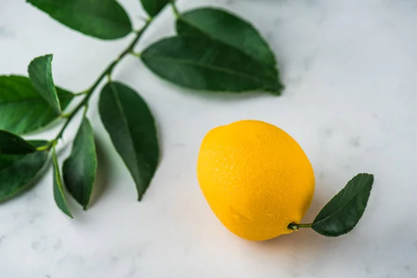 sweet candy in lemon shape on white background with leaves