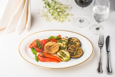 tabak, çatal bıçak ile ve gözlük şarap ve su tablo ile lezzetli ızgara sebze