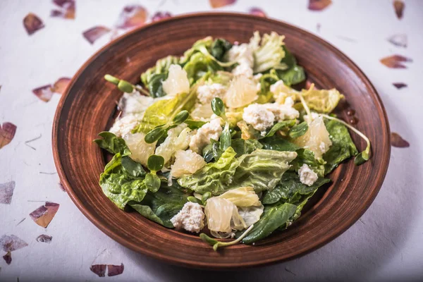 Fresh snack salad with chicken, pineapple and seeds in plate