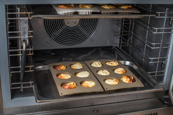 cooking cakes on baking tray in oven