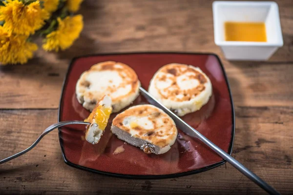 Ahşap masa çiçekli tabakta üzerine kızarmış peynir börek