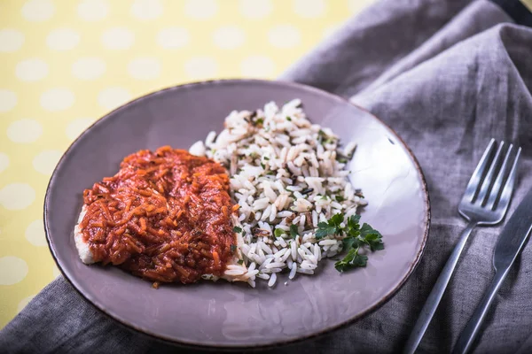 Rice with meat in tomato sauce served on plate