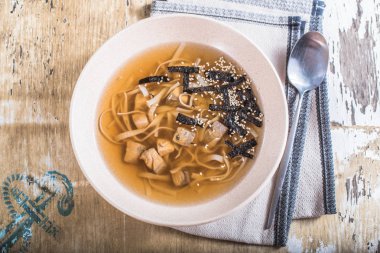 Berbat ahşap masada kase balık noodle ile Asya çorbası