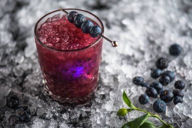 Stick buz ile koyu arka plan üzerinde yaban mersini taze kokteyl cam süslenmiş