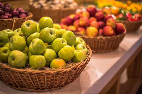 Basket of fresh green apples at farmer market