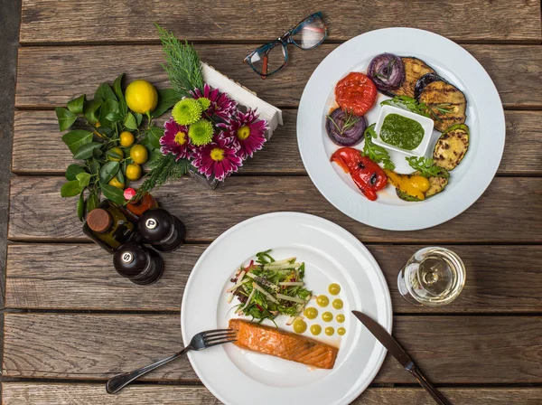 Abendessen Mit Lachs Salat Und Gegrilltem Gemüse Auf Tellern Auf — Stockfoto