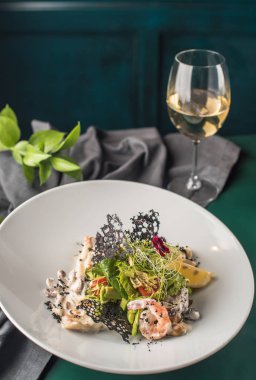 Deniz ürünleri meze koyu arka plan üzerinde beyaz plaka üzerinde