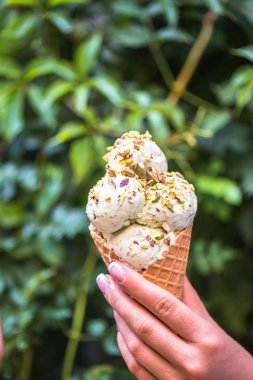 Waffle koni içinde insan el tutan badem dondurma