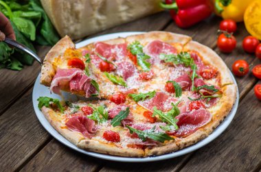 et, roka, parmesan ve kiraz domates gurme pizza ahşap masa üzerinde görmek