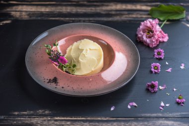 Ahşap masa üzerinde yenilebilir çiçekler ile dekore edilmiş patates püresi bölümünü