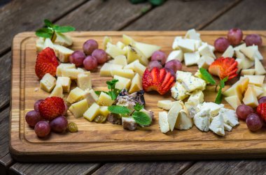 meze ahşap tahta, peynir ve çilek ile