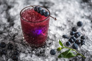 Stick buz ile koyu arka plan üzerinde yaban mersini taze kokteyl cam süslenmiş