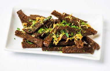 Kızarmış ekmek sopalarla otlar ve baharatlar beyaz arka plan üzerinde plaka üzerinde